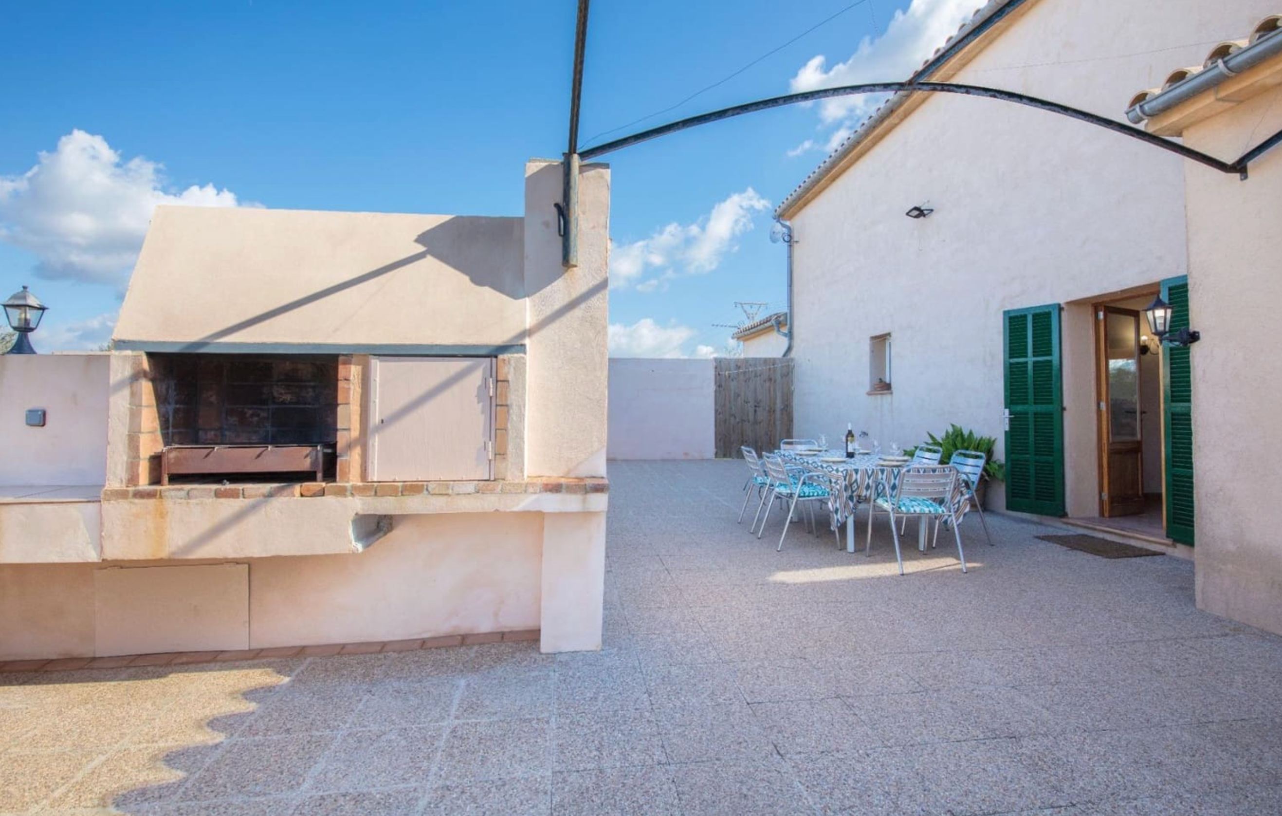 Outdoor BBQ area with built-in grill and dining space