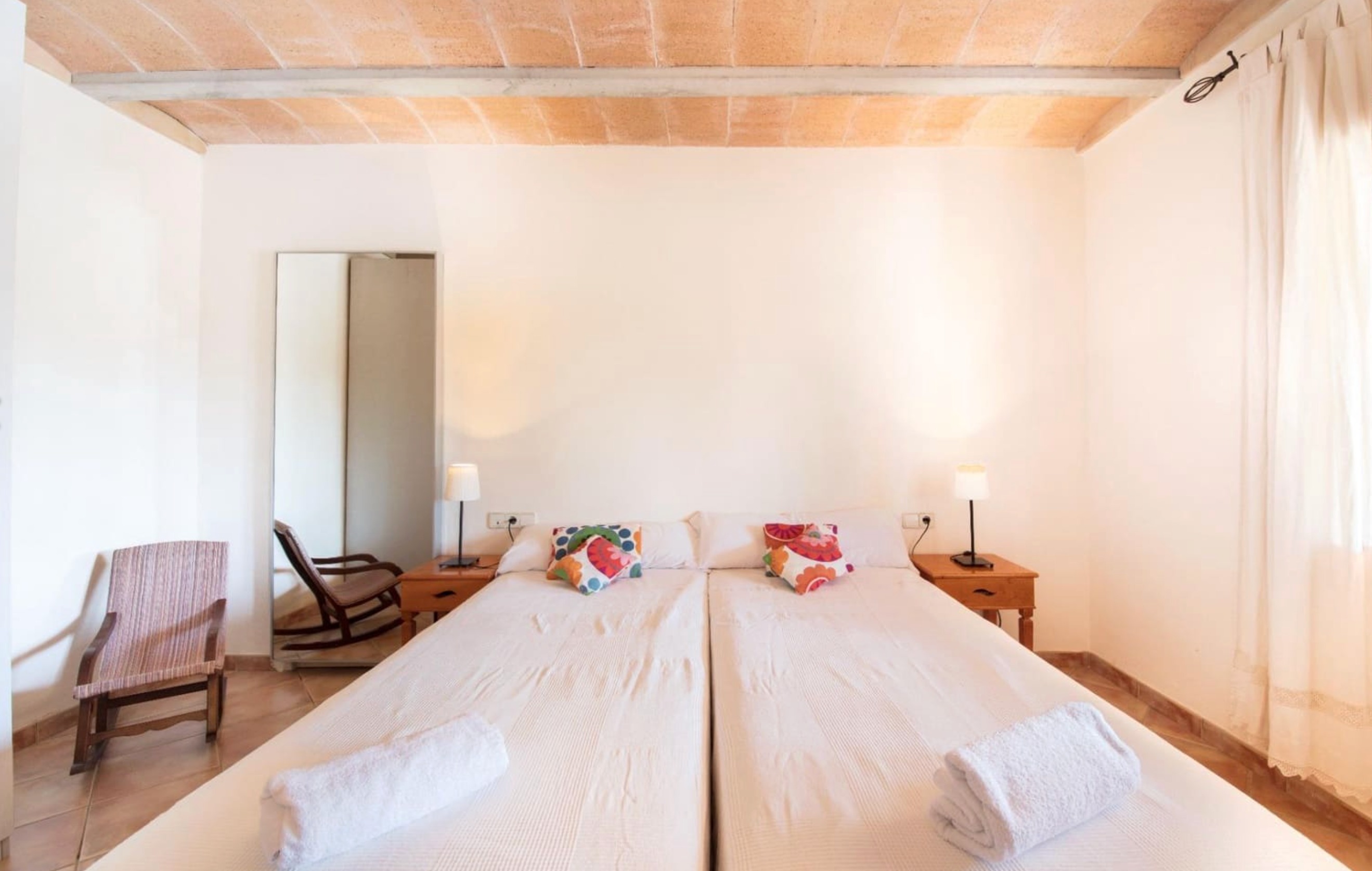 Bedroom with twin beds and colorful pillows