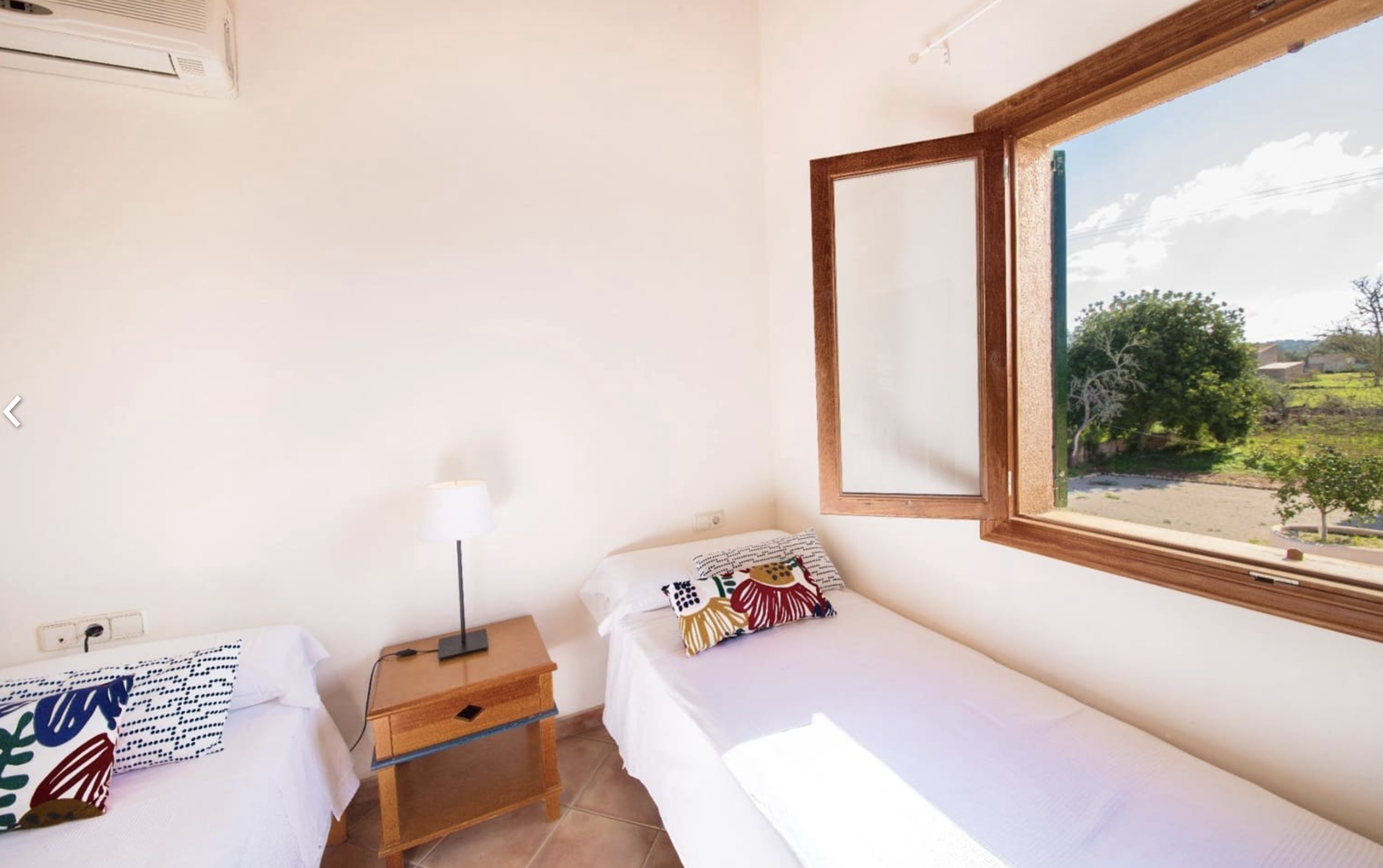 Twin bedroom with countryside views through large window