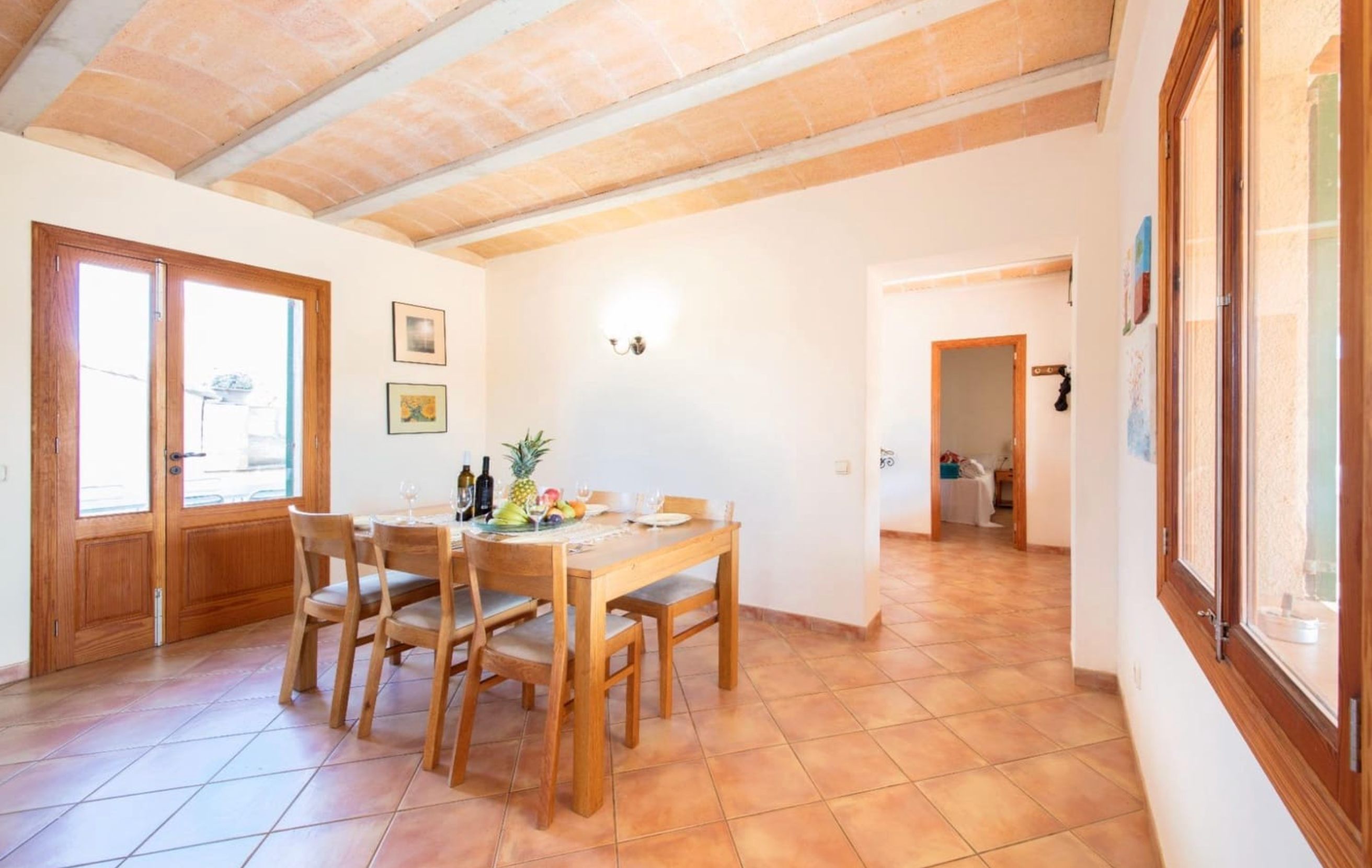 Dining area with wooden table and traditional terracotta flooring