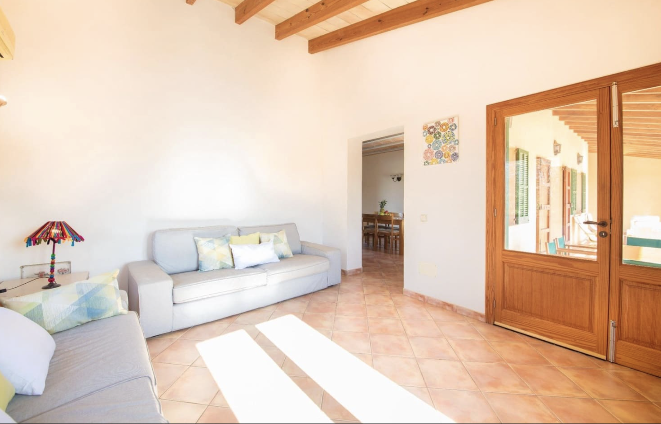 Bright living area with natural light and terracotta floors